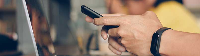 Businessman using laptop and typing on mobile smart phone, business people with technology