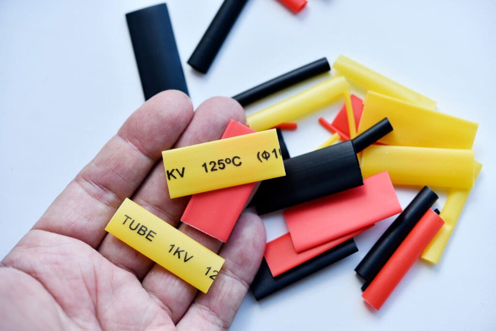 a person holding labeled yellow heat shrink